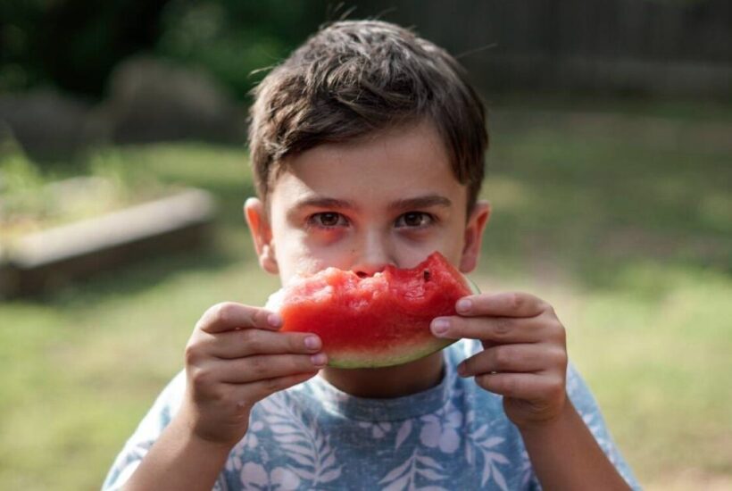 A boy eating a watermelon